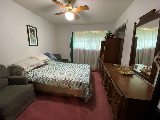 Bedroom with dark carpet and ceiling fan | Image 12