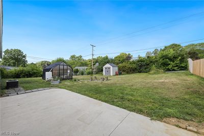 View of yard with a patio area and a shed | Image 3