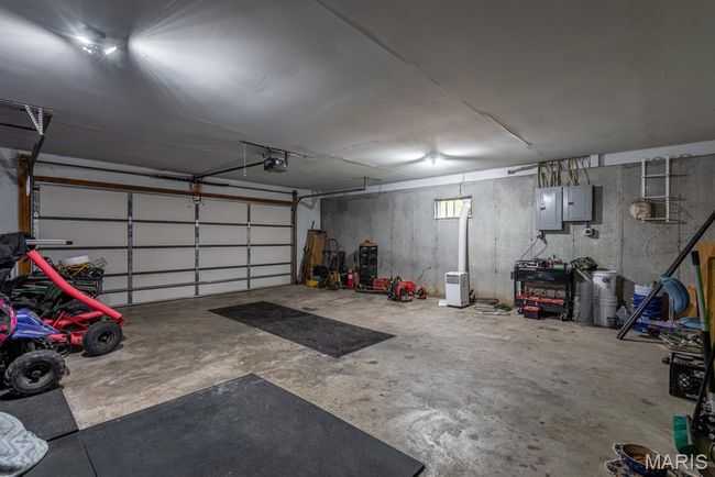 Garage with electric panel and a garage door opener | Image 19