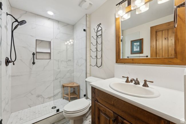 Full bath with toilet, a marble finish shower, and vanity | Image 23