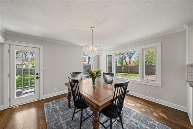 Dining space with an inviting chandelier, a wealth of natural light, and baseboards | Image 6