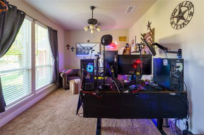 Game room with a healthy amount of sunlight, carpet flooring, and ceiling fan | Image 3