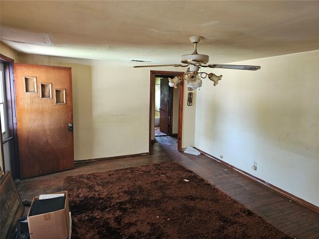 Spare room with dark wood finished floors and ceiling fan | Image 4