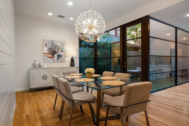 Dining room with wood finished floors, recessed lighting, a chandelier, and baseboards | Image 9