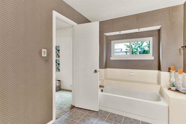 Bathroom featuring a garden tub and tile patterned floors | Image 17