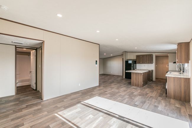 Kitchen is adjacent to the den. | Image 16
