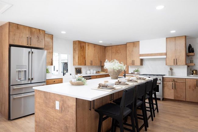 Custom hand built cabinets and porcelain backsplash along with upgraded appliances are the highlights of this kitchen | Image 14