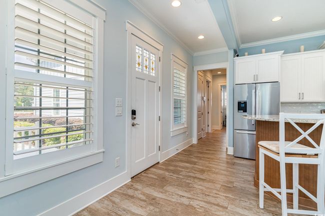 Foyer with recessed lighting, light wood-style flooring, crown molding, and baseboards | Image 9