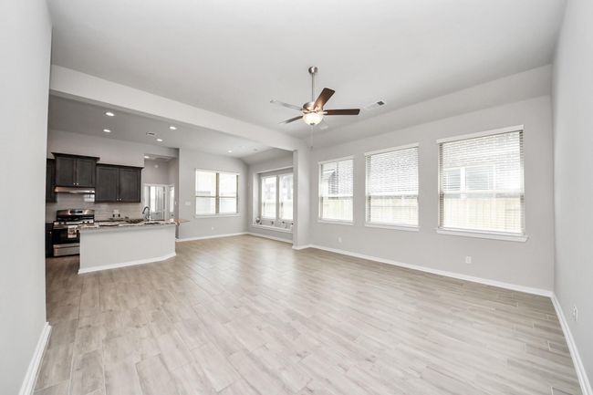 Spacious open-concept living room with abundant natural light | Image 12