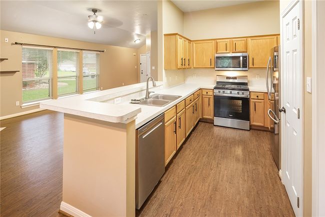 Kitchen open to living and dining. Newer Stainless appliances. | Image 8