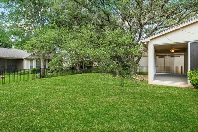 View of yard featuring a sunroom and ceiling fan | Image 22