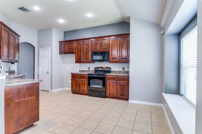 Another glimpse of the kitchen designed for easy movement and everyday flow. | Image 16