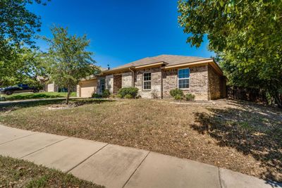 Ranch-style house featuring a garage and a front lawn | Image 3