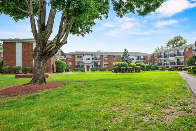 View of home's community with a residential view and a lawn | Image 29