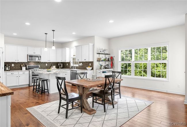 Open layout seamlessly connects the eat-in kitchen to the family room | Image 7