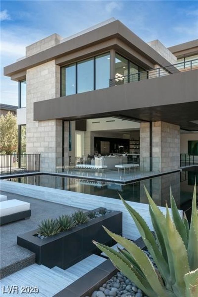 Back of property with a balcony and stone siding | Image 45