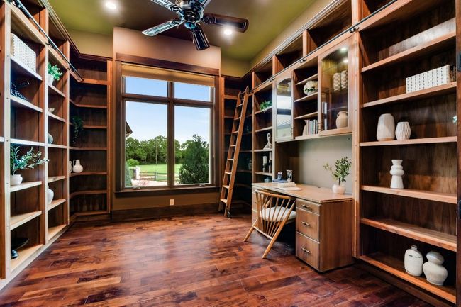 Library/office with built ins and expansive window. | Image 9