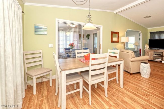 Dining area featuring hardwood / wood-style floors, lofted ceiling with beams, and ornamental molding | Image 9