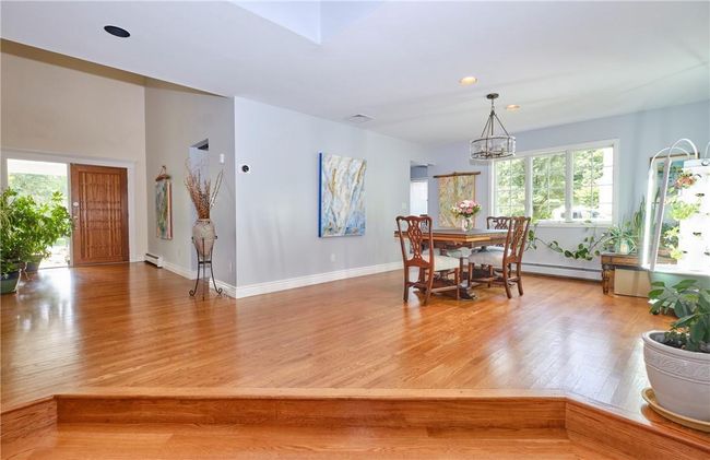 Dining space with a baseboard heating unit and wood-type flooring | Image 18