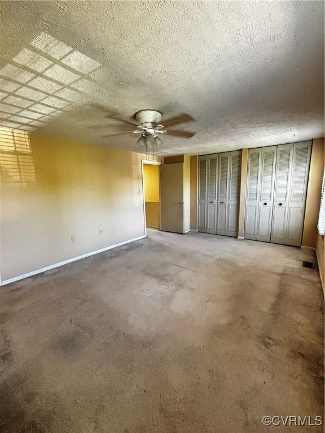Unfurnished bedroom featuring baseboards and ceiling fan | Image 12