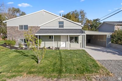 Rear view of property featuring a carport and a lawn | Image 1