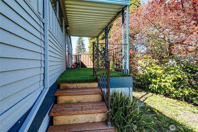 Stairs from the back deck leading to the yard. | Image 30