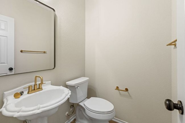 Half bath with toilet, a sink, and baseboards | Image 15