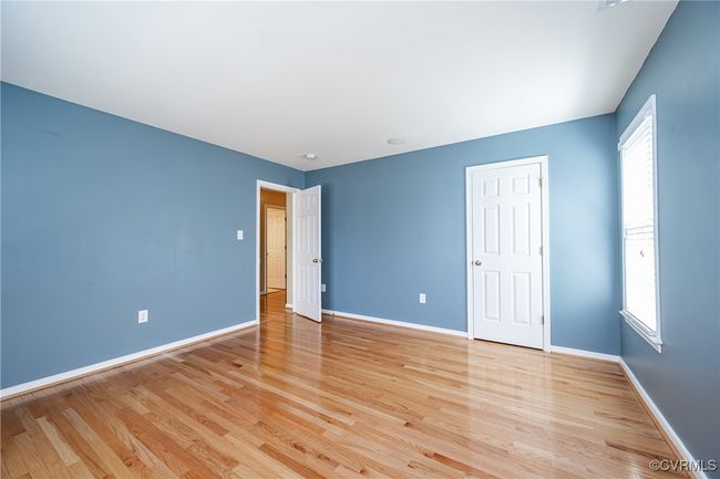 Unfurnished bedroom featuring light wood-type flooring and baseboards | Image 28