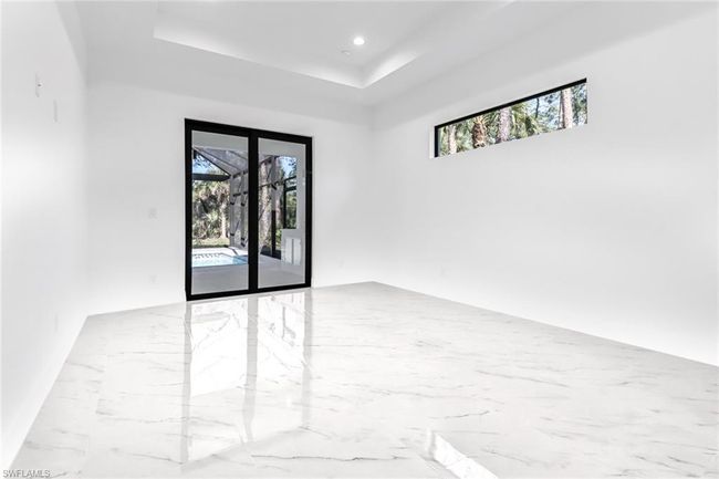 Spare room with light tile patterned flooring and a tray ceiling | Image 21