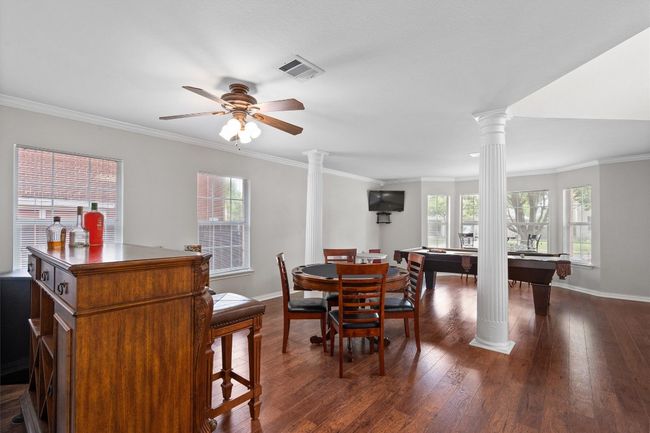 Great view of the formal dining area overlooking the second living space. | Image 21