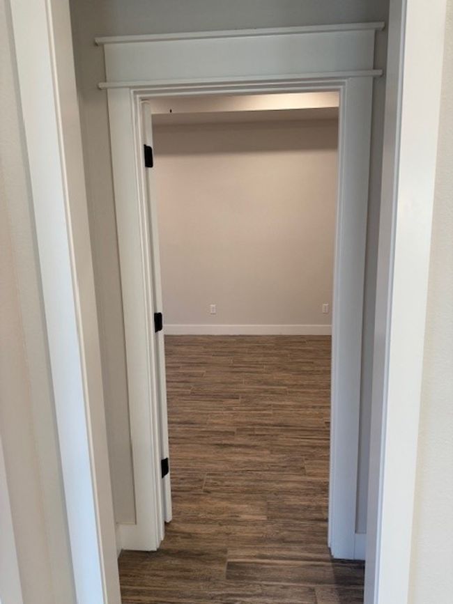 Hallway featuring wood finished floors and baseboards | Image 31