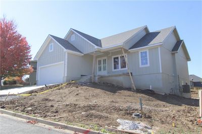 View of front facade featuring central AC and a garage | Image 1