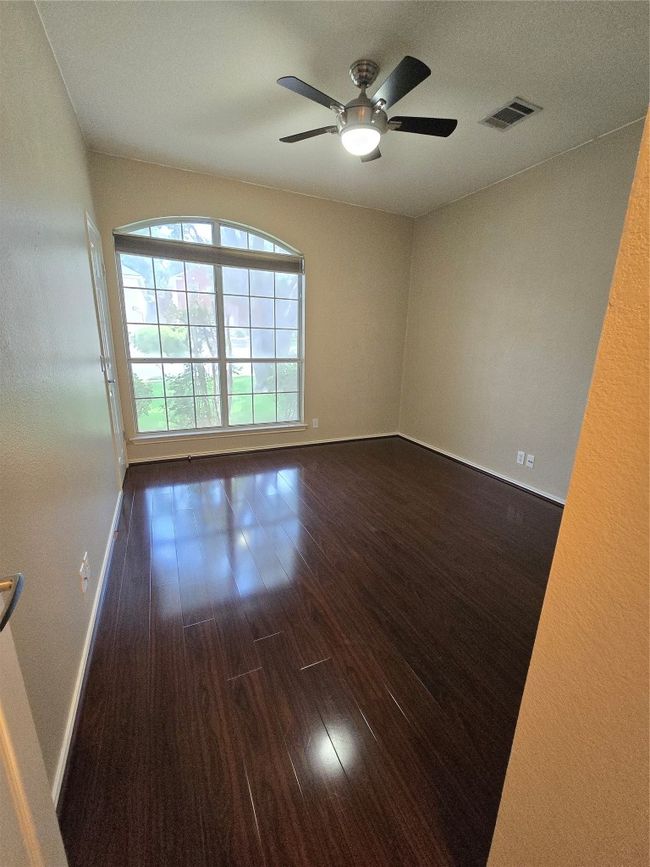 Spare room with dark wood-style flooring, a ceiling fan, and a textured ceiling | Image 7