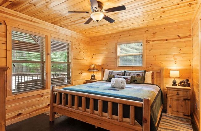Bedroom featuring wood ceiling, wooden walls, and a ceiling fan | Image 23