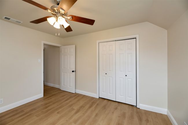 Unfurnished bedroom with light wood finished floors, baseboards, and ceiling fan | Image 19