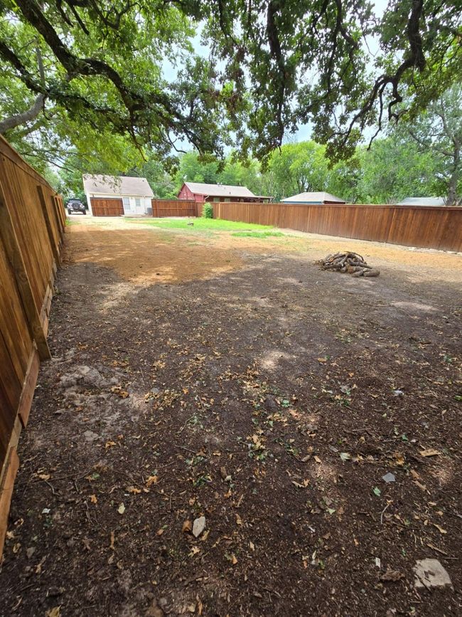 View of fenced backyard | Image 7