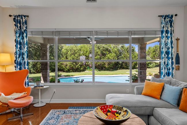 Picture windows in the family room showcase the pool | Image 7