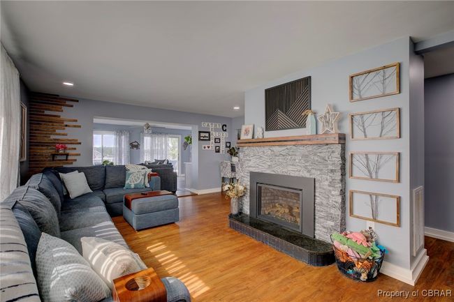 Living room featuring hardwood / wood-style floors and a stone fireplace | Image 26