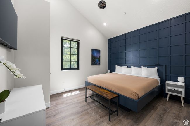 Bedroom with high vaulted ceiling and hardwood / wood-style floors | Image 40