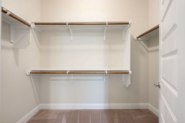 Walk in closet with carpet floors | Image 16