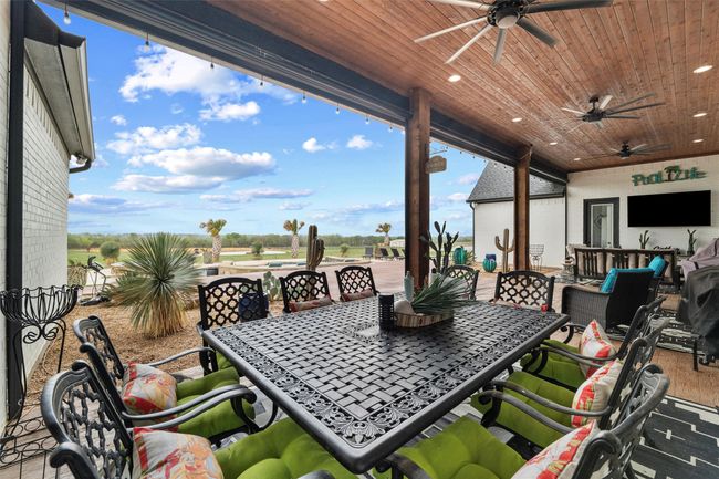 View of patio / terrace featuring a ceiling fan and outdoor dining area | Image 23