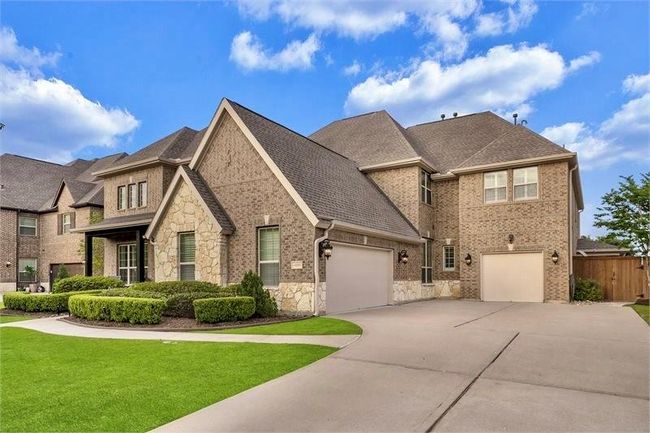 Plenty of driveway space for parking and 3-car garage equipped with automatic door openers for convenience. | Image 5