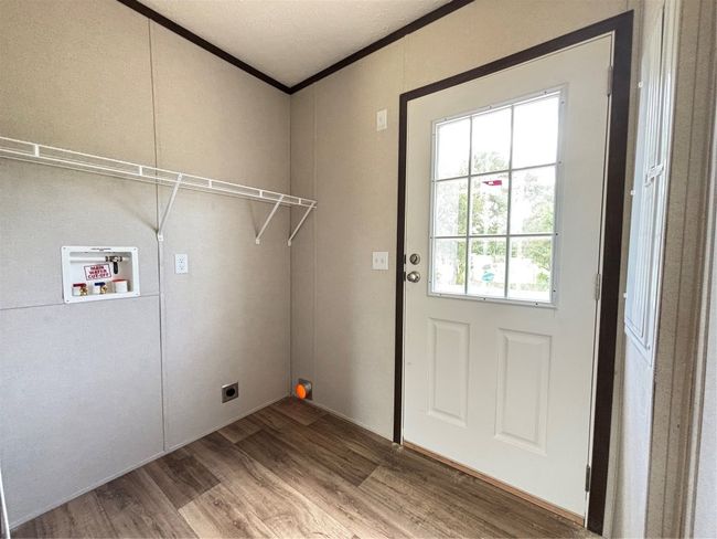 Washroom with washer hookup, wood finished floors, hookup for an electric dryer, and ornamental molding | Image 16