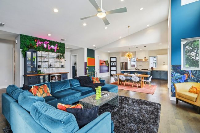 Living room featuring recessed lighting, wood finished floors, vaulted ceiling, and a ceiling fan | Image 9