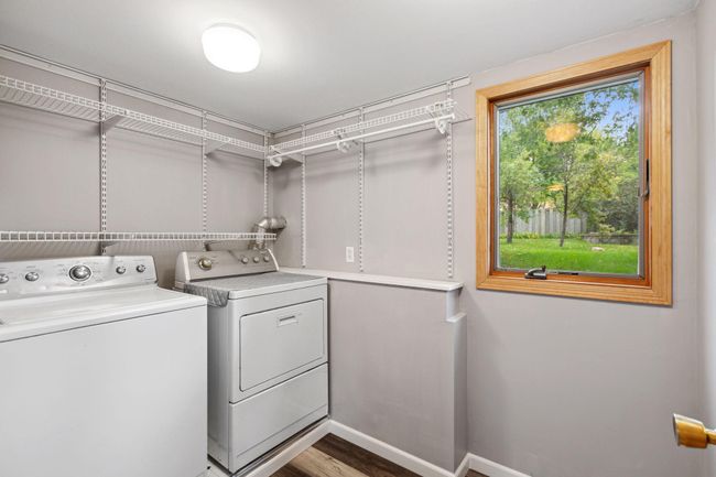 Main floor laundry room with storage shelves. | Image 27