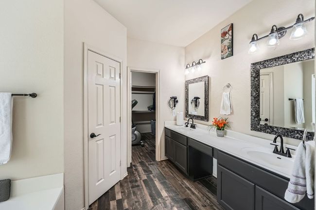 Bathroom with double vanity and wood finished floors | Image 20