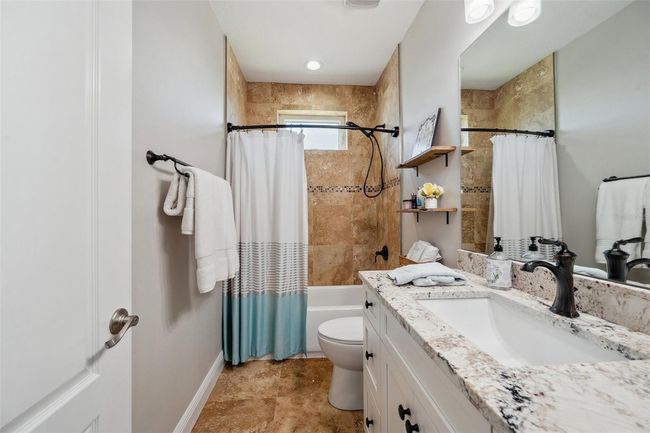 Shared bathroom on 3rd floor includes solid wood vanity with stone counter. | Image 72
