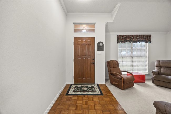 Foyer entrance with ornamental molding and baseboards | Image 6