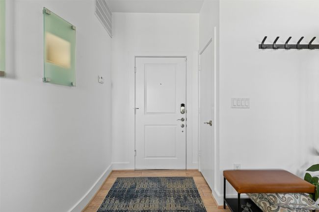 Doorway featuring light wood-type flooring, baseboards, and visible vents | Image 23