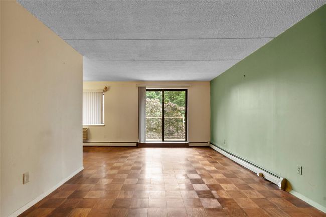 room with baseboard heating and a textured ceiling | Image 5